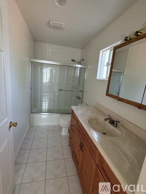 A bathroom with a sink, toilet, and shower.