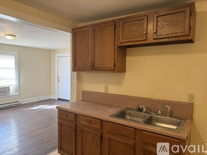 A kitchen with wooden cabinets and a marble countertop.