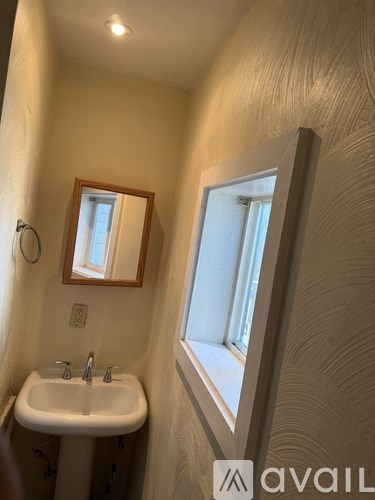 A bathroom with a sink and mirror.
