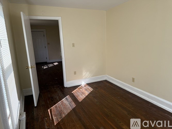 A room with wooden floors and a white door.