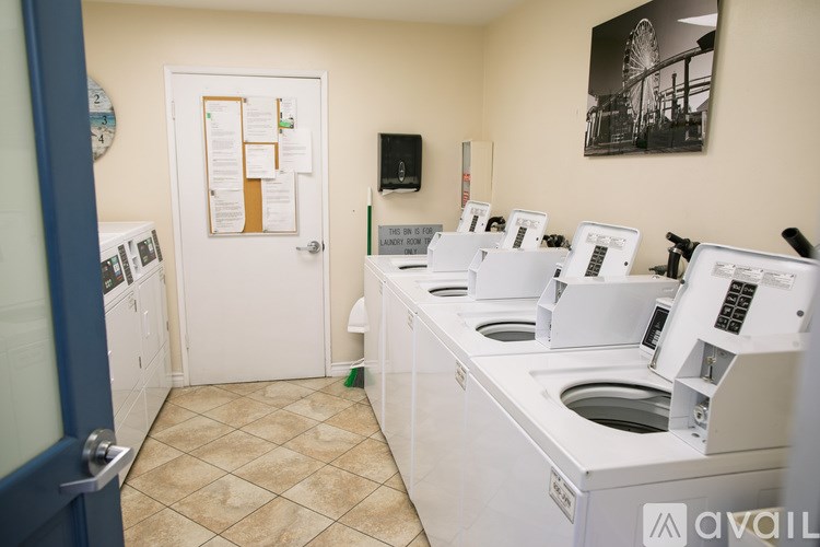 A laundry room with washers and dryers.