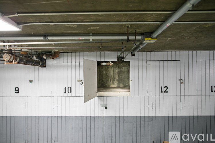 A ventilation hood is hanging from the ceiling in a room with white walls.