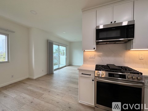 A kitchen with a stove top oven and microwave above it.