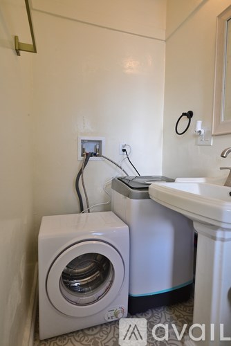 A small laundry room with a washer and dryer.