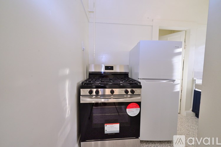 A black stove with a red sticker on it.