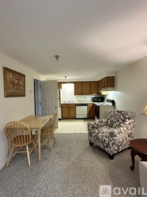 A living room with a dining table and chairs.