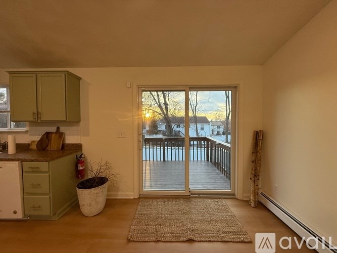 A kitchen with green cabinets and a white dishwasher is shown.