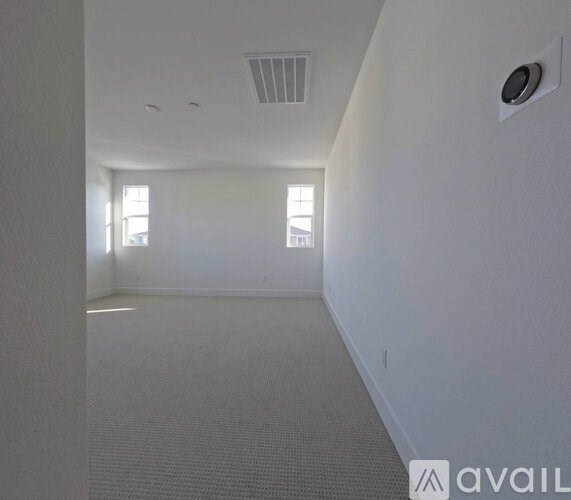 A room with a window and a ceiling fan.