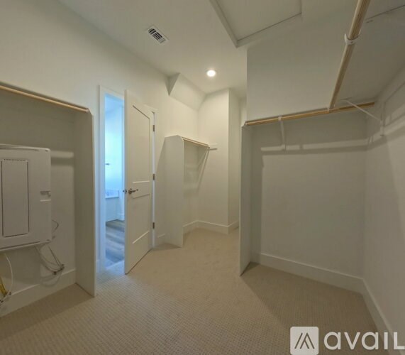 A room with a white door and a white wall.