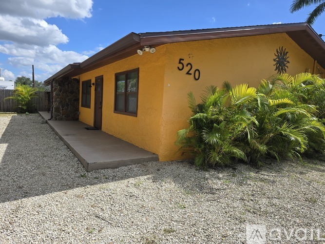 A yellow house with the number 520 on it.