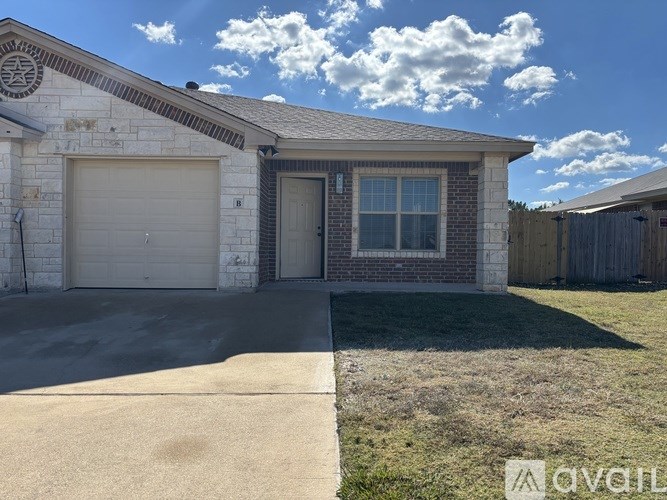 A house with a garage door and a window is shown.