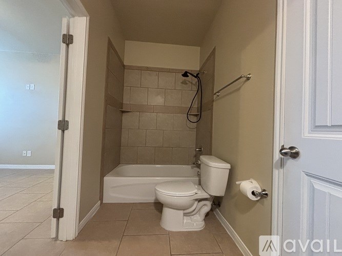 A bathroom with a toilet, tub, and shower.