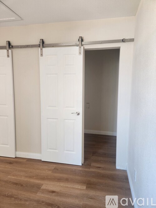 A room with a white door and a white wall.