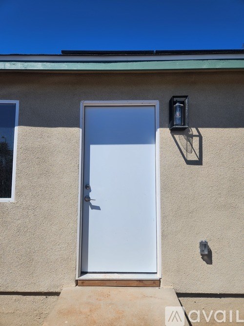 A house with a white door and a window on the side.