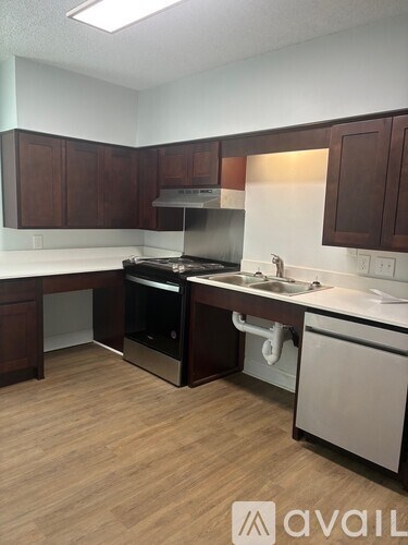 A kitchen with wooden cabinets and a white countertop.