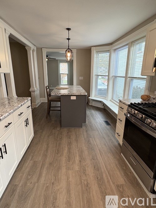 A kitchen with a table and chairs in the middle of the room.