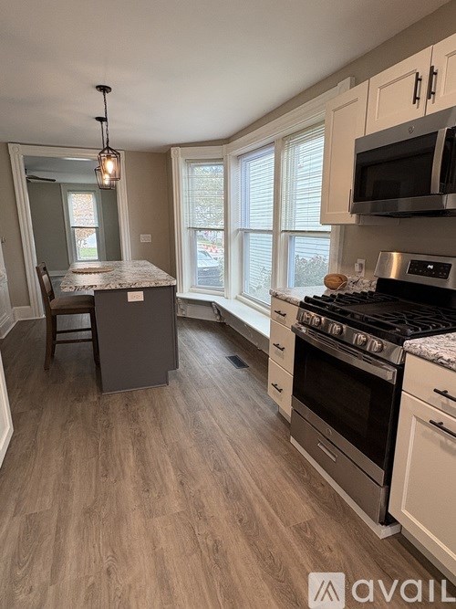 A kitchen with a stove top oven and a microwave above it.