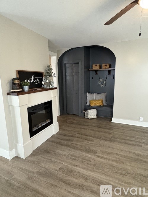 A living room with a fireplace and a grey door.