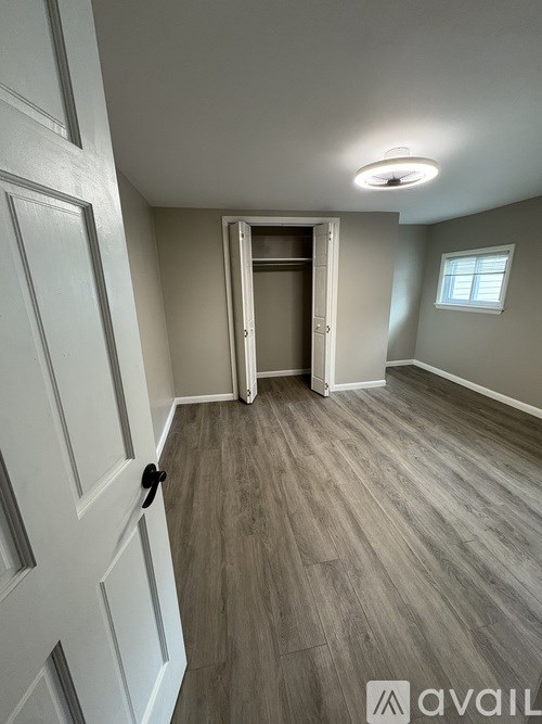 A room with a white door and a window.