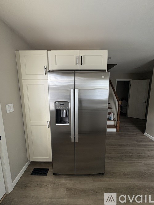 A stainless steel refrigerator with a water and ice dispenser in the middle.