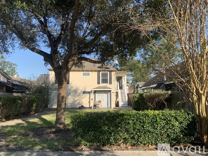 A house with a tree in front of it.