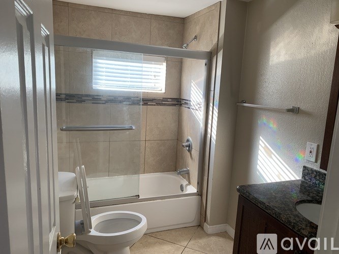 A bathroom with a toilet, sink, and shower.