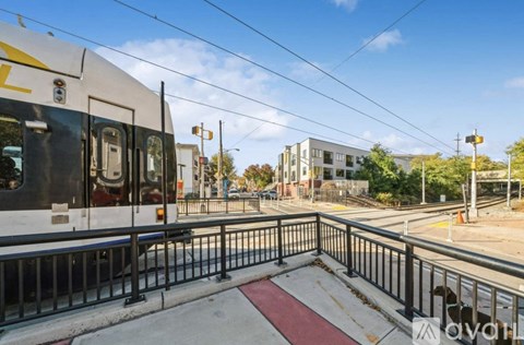 A train is on the tracks with a building in the background.