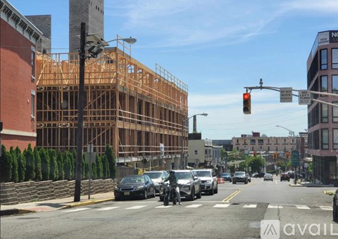 A street view with cars stopped at a red light.