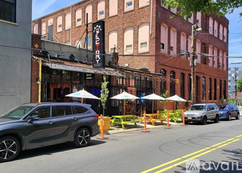 A grey SUV is parked on the side of the street.