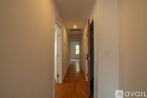 A long hallway with doors on both sides.