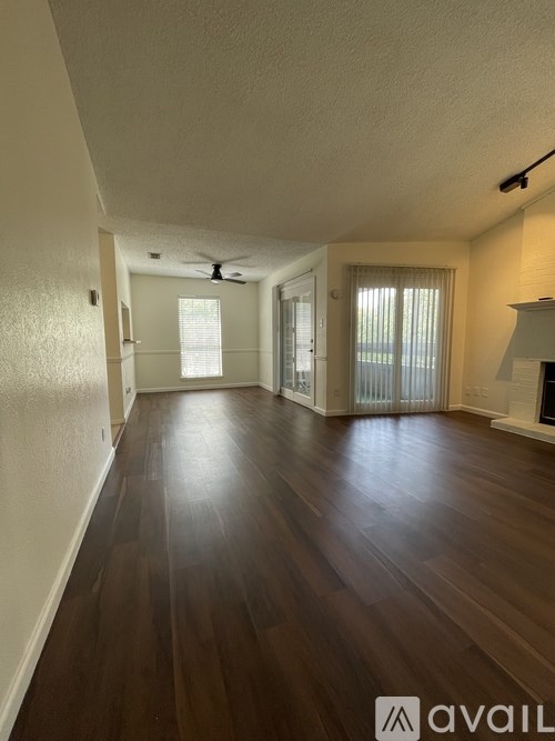 A room with wooden floors and a ceiling fan.