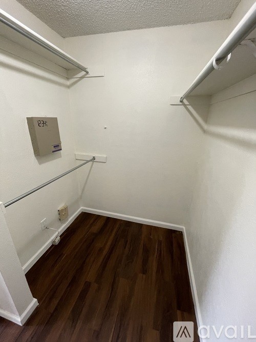 A small room with a wooden floor and white walls.