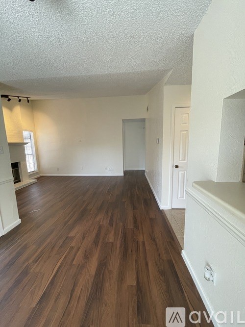 A room with wooden floors and white walls.