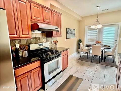 A kitchen with a stove top oven and a refrigerator.