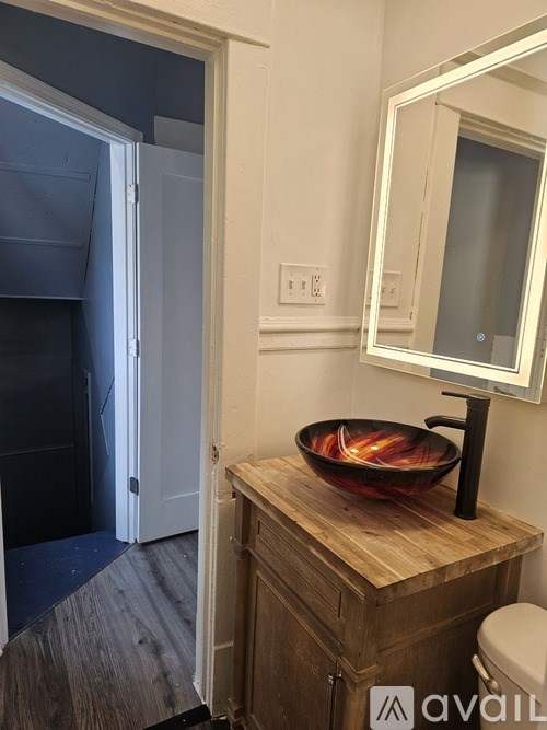 A bathroom with a wooden cabinet and a bowl on top of it.