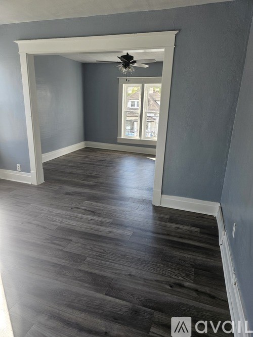 A room with a fan and a window.