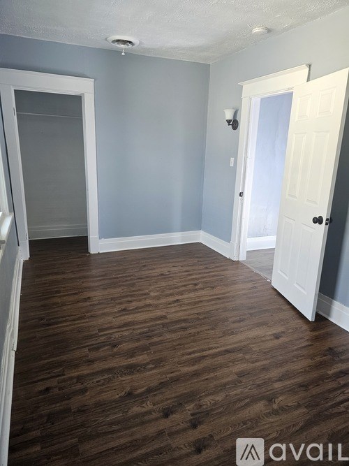 A room with wooden floors and white doors.