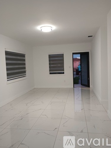 A room with white walls and a tiled floor.