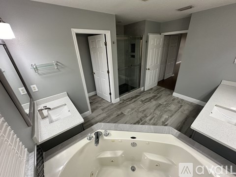 A bathroom with a tub, toilet, and sink.