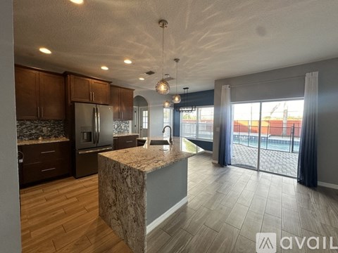 A kitchen with a granite island in the middle of the room.