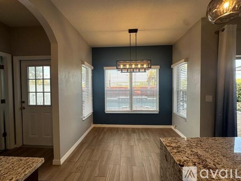 A room with a marble countertop and wooden flooring.