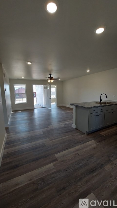 A kitchen area with wooden floors and a cabinet.