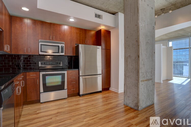 A kitchen with wooden cabinets and stainless steel appliances.