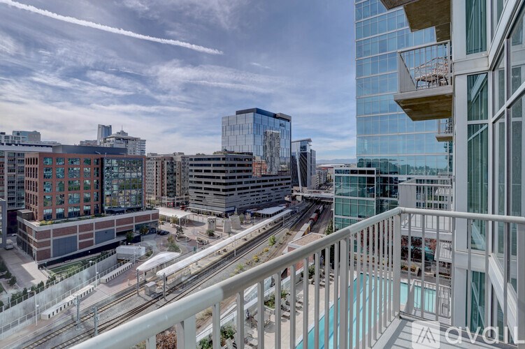 A modern cityscape with a train track running through the middle.