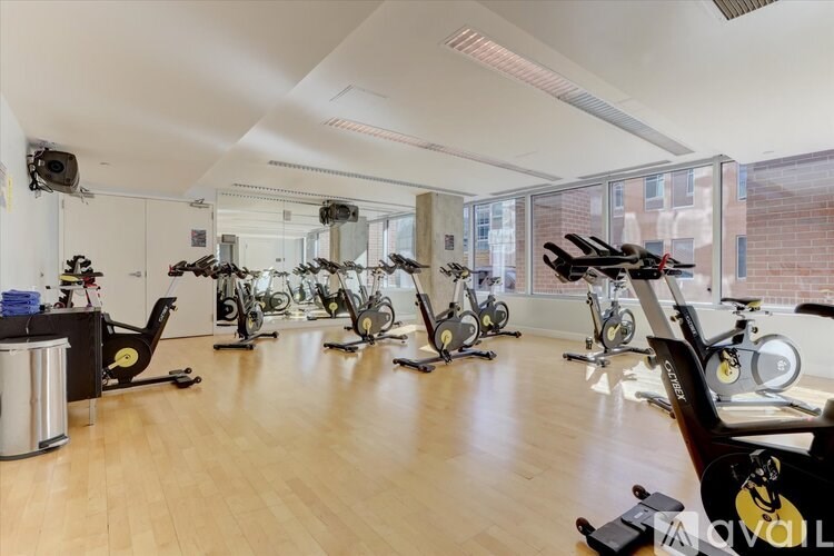 A room full of exercise bikes and a TV mounted on the wall.