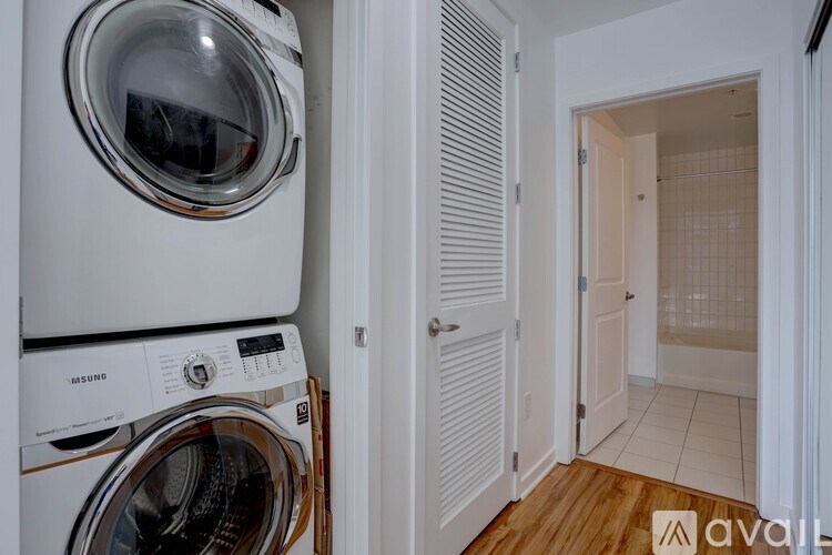A stack of white washing machines in a small room.
