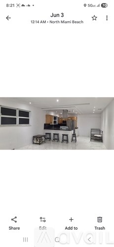 A room with a bar and stools is shown in the image.