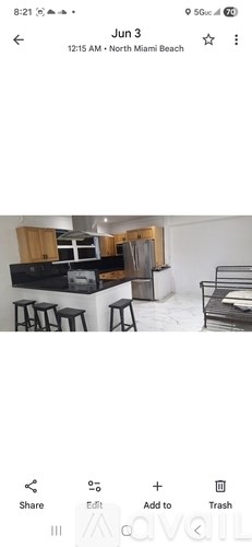 A kitchen with a bar stool and a counter.