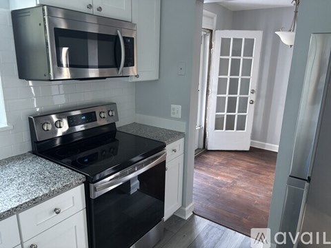 A kitchen with a stove top oven and microwave above it.