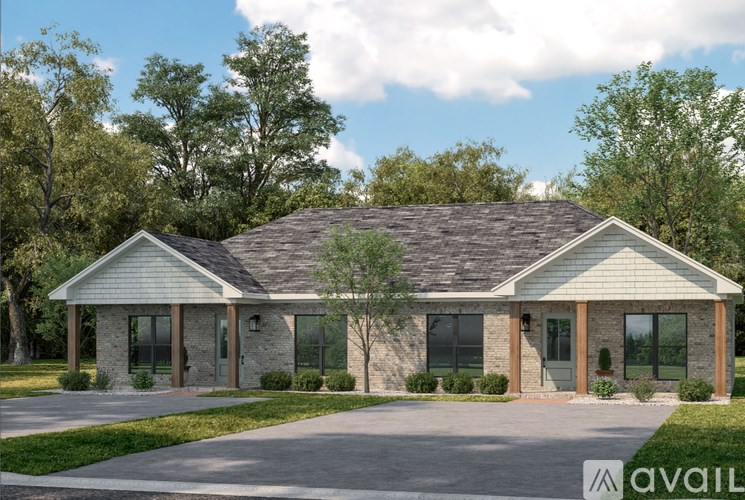 A house with a grey roof and a driveway in front.